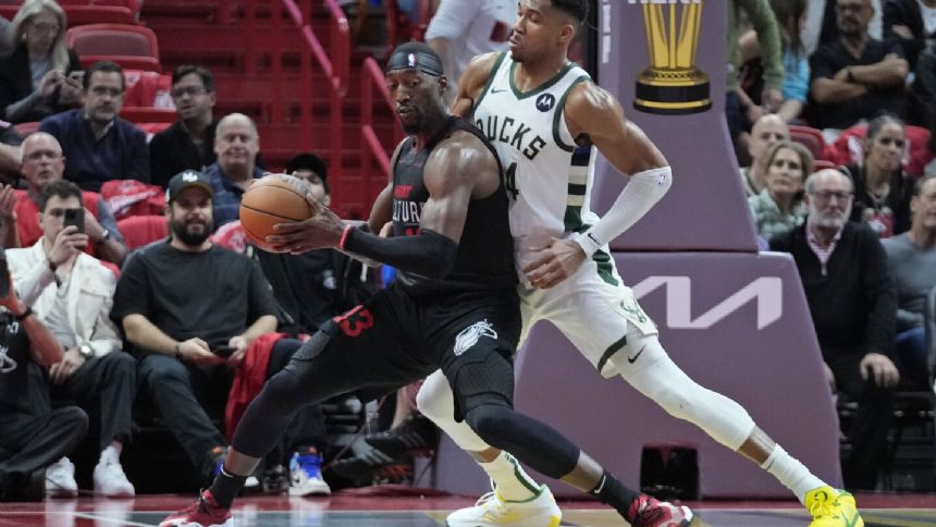 Antetokounmpo, Lillard combine for 65, and Bucks earn quarterfinal berth by topping Heat 131-124