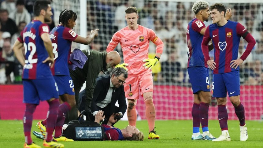 Barcelona midfielder De Jong leaves 'clasico' on a stretcher after right leg injury