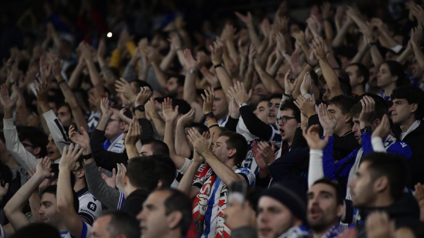 Benfica fans throw flares toward Sociedad supporters at Champions League match