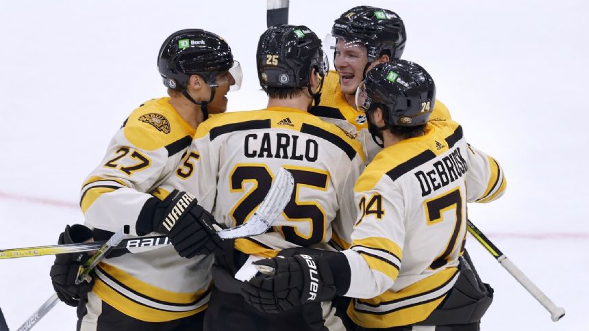 Bruins' 1970 and 1972 Stanley Cup winners finally raise banner to rafters
