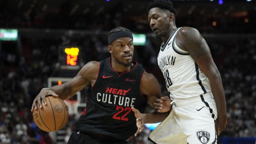 Butler scores 36, Robinson adds 26 and Heat top Nets 122-115 to win 7th straight