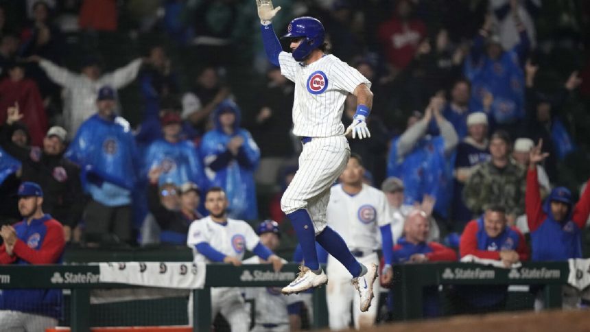 Dansby Swanson hits a tiebreaking 2-run homer as the Cubs top the Reds 7-5 at a wet Wrigley Field