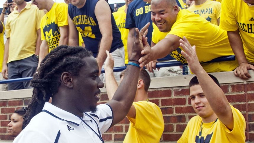 Ex-Michigan star QB Denard Robinson no longer part of staff, suspected of driving while intoxicated