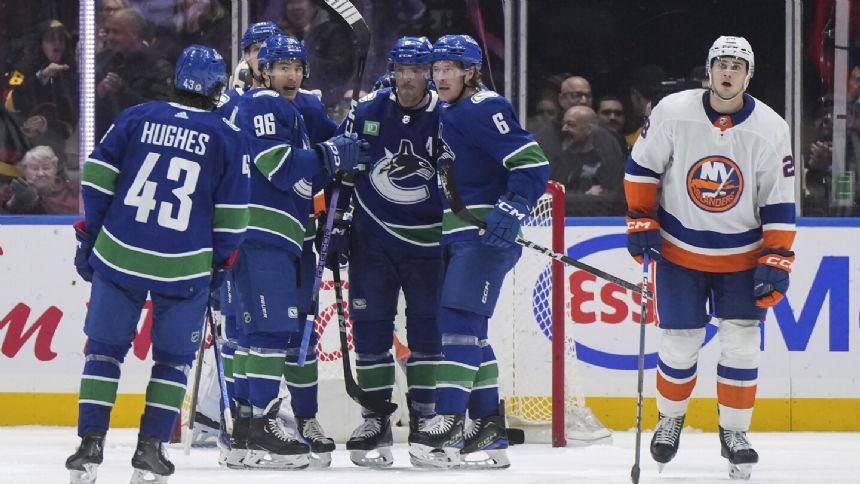 Hughes scores in OT to give Canucks 4-3 win over Islanders