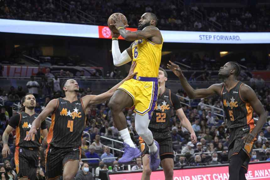 James scores 29, plays center as Lakers rally past Magic