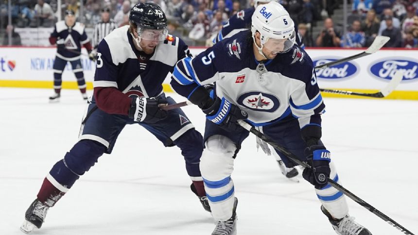 Jets defenseman Brenden Dillon heads to locker room with hand bleeding after fight following game