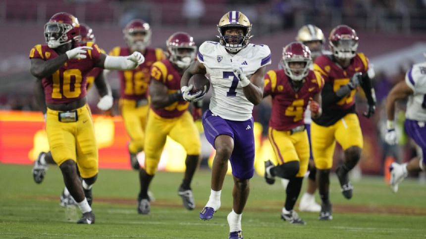 Johnson runs for 256 yards, 4 TDs in No. 5 Washington's high-octane 52-42 win over No. 24 USC