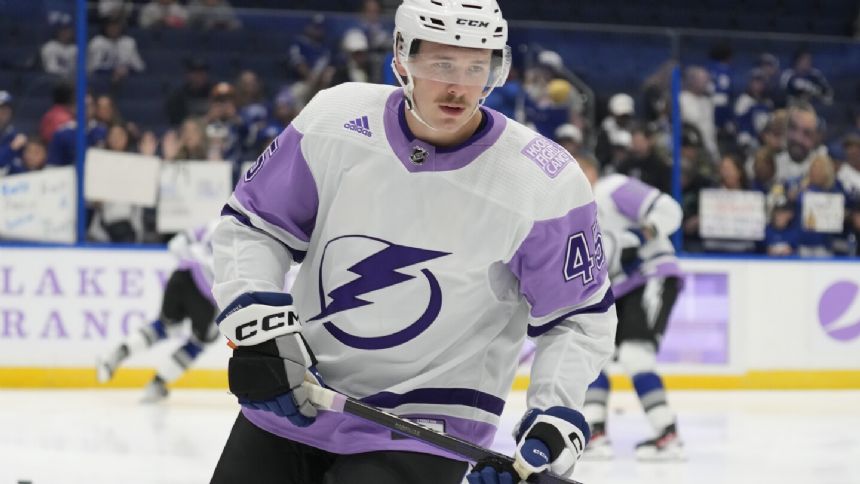 Lightning left wing Cole Koepke wearing neck guard following the death of Adam Johnson
