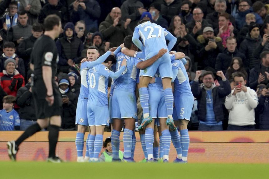 Man City stays serene in title charge on wild night in EPL