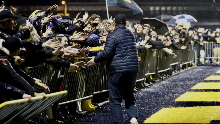 Michigan Wolverines return home to screaming fans after victory over Washington Huskies