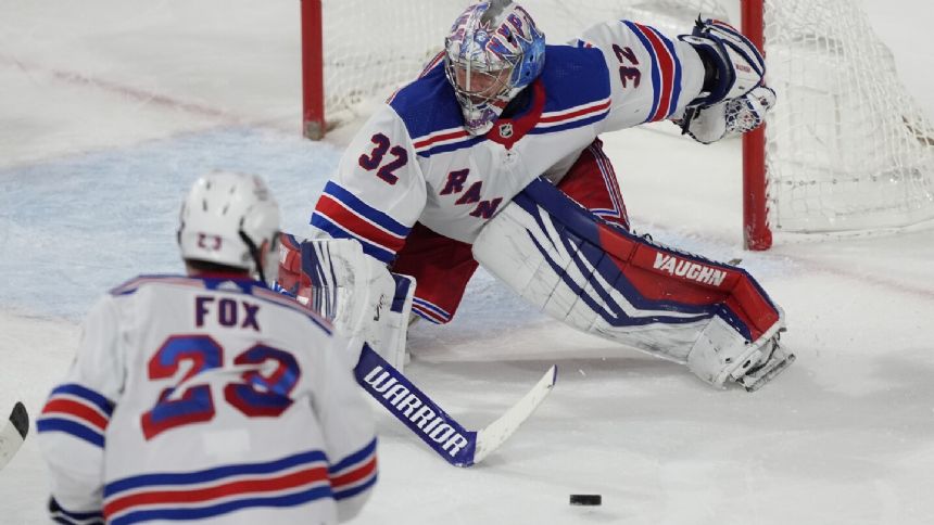 NHL-leading Rangers get 50th win, Quick sets US record in 8-5 victory over Coyotes