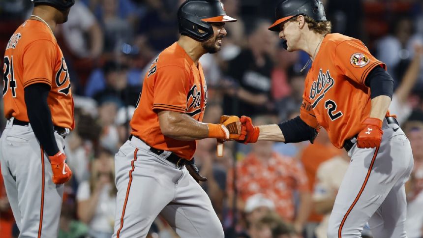 Orioles hang on to beat Red Sox 13-12 for 7th straight win as McCann homers twice