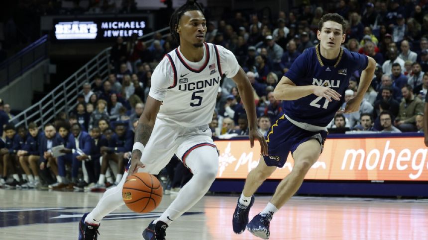 UConn unveils championship banner, opens title defense with 95-52 rout of N. Arizona