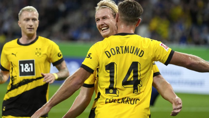 Uneven Dortmund holds on with 10 men to beat Hoffenheim 3-1 in the Bundesliga