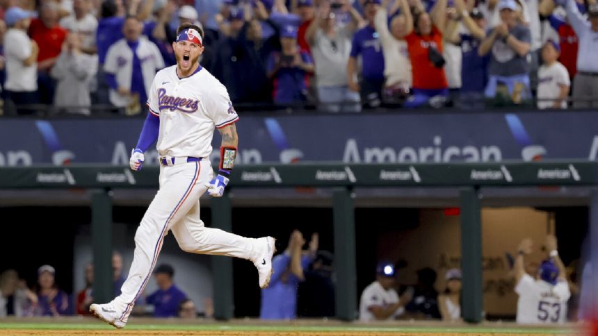 World champion Rangers overcome disputed tip and beat Cubs 4-3 on Heim's 10th-inning single